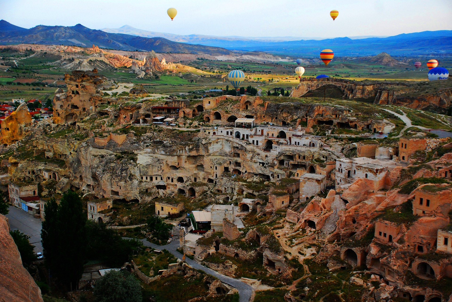 Panoramic view of cappadocia cave and hot air balloons. An unique itinerary enables you to enjoy the 2 different cultures and know more than 12 cities.